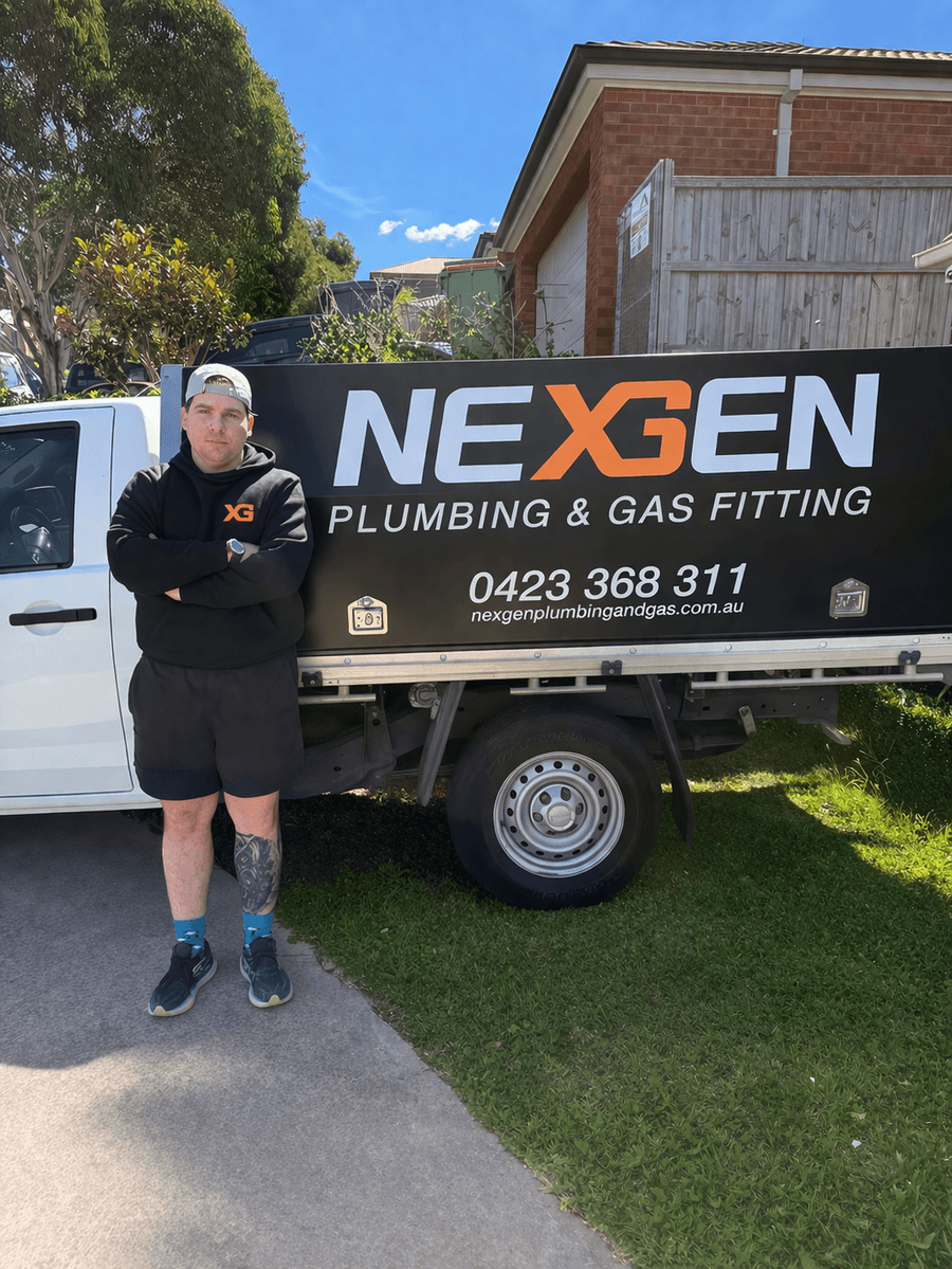 Ben from Nexgen Plumbing and Gasfitting standing next to his work van in Sunbury