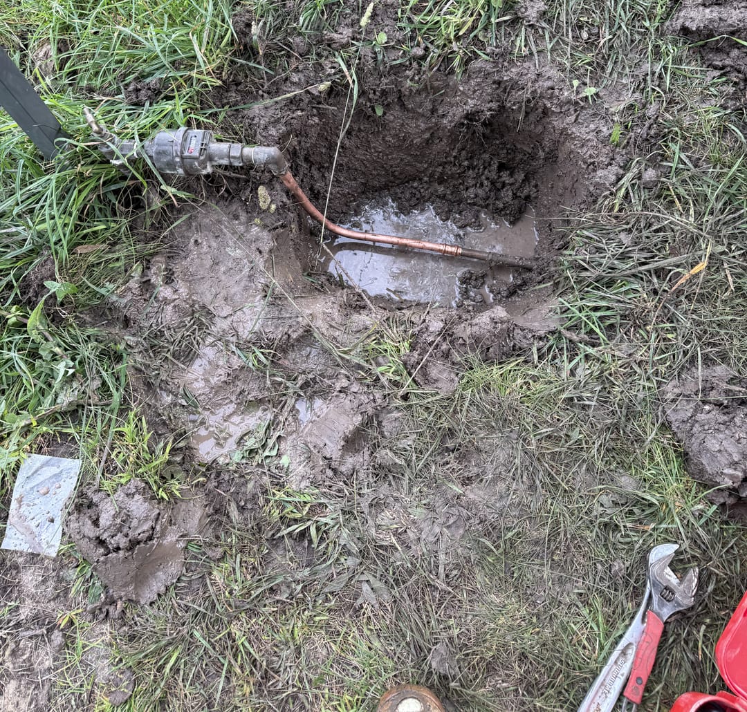 Emergency plumber repairing a burst water pipe