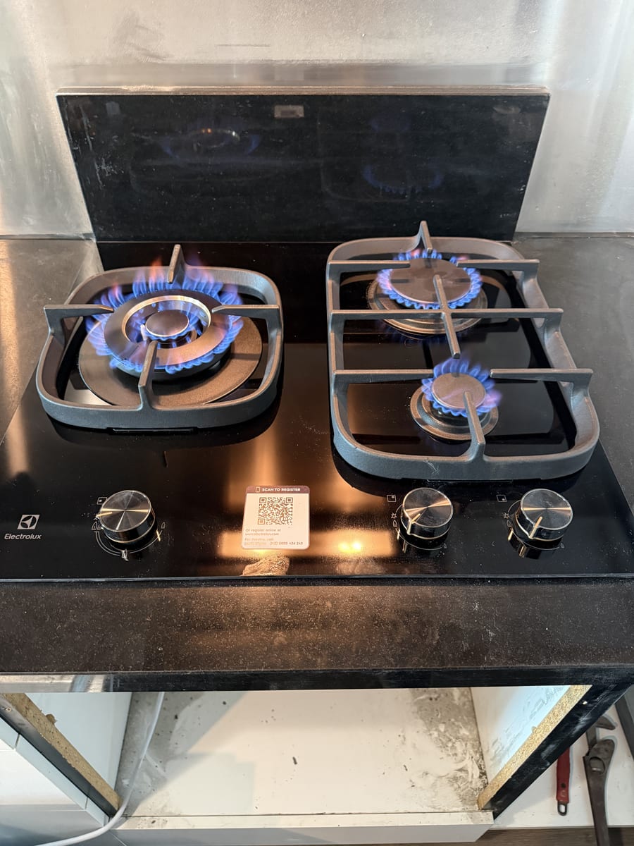 Newly installed gas cooktop flame tested by a licensed gasfitter